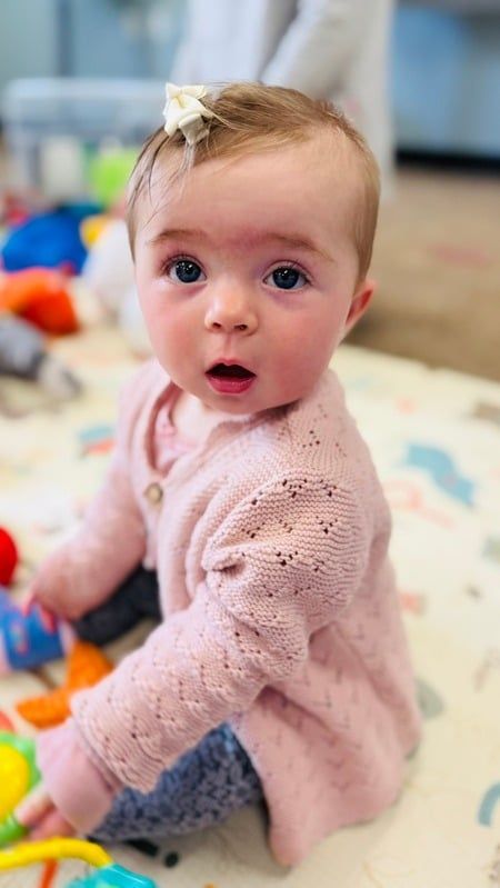 Scarlett as a smiling baby